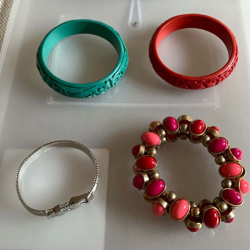 4 Bracelets Silver one can hold charms. Pinkish colored one from Holts.